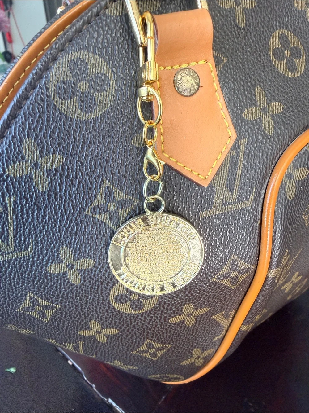 LV gold tone “trunks & bags” bag charm on a new Lobster claw swivel hook. GUC